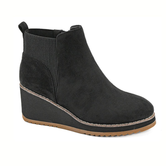 The Apple Sauced Black Faux Suede Ankle Boot by CORKY'S FOOTWEAR INC features an elastic side panel and brown rubber sole, making it a stylish addition to any women's bootie collection.