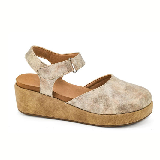 The All in Low Wedge in Rose Gold by CORKY'S FOOTWEAR INC features a closed toe, ankle strap with buckle, cushioned insole, and thick wedge sole, photographed against a white background.