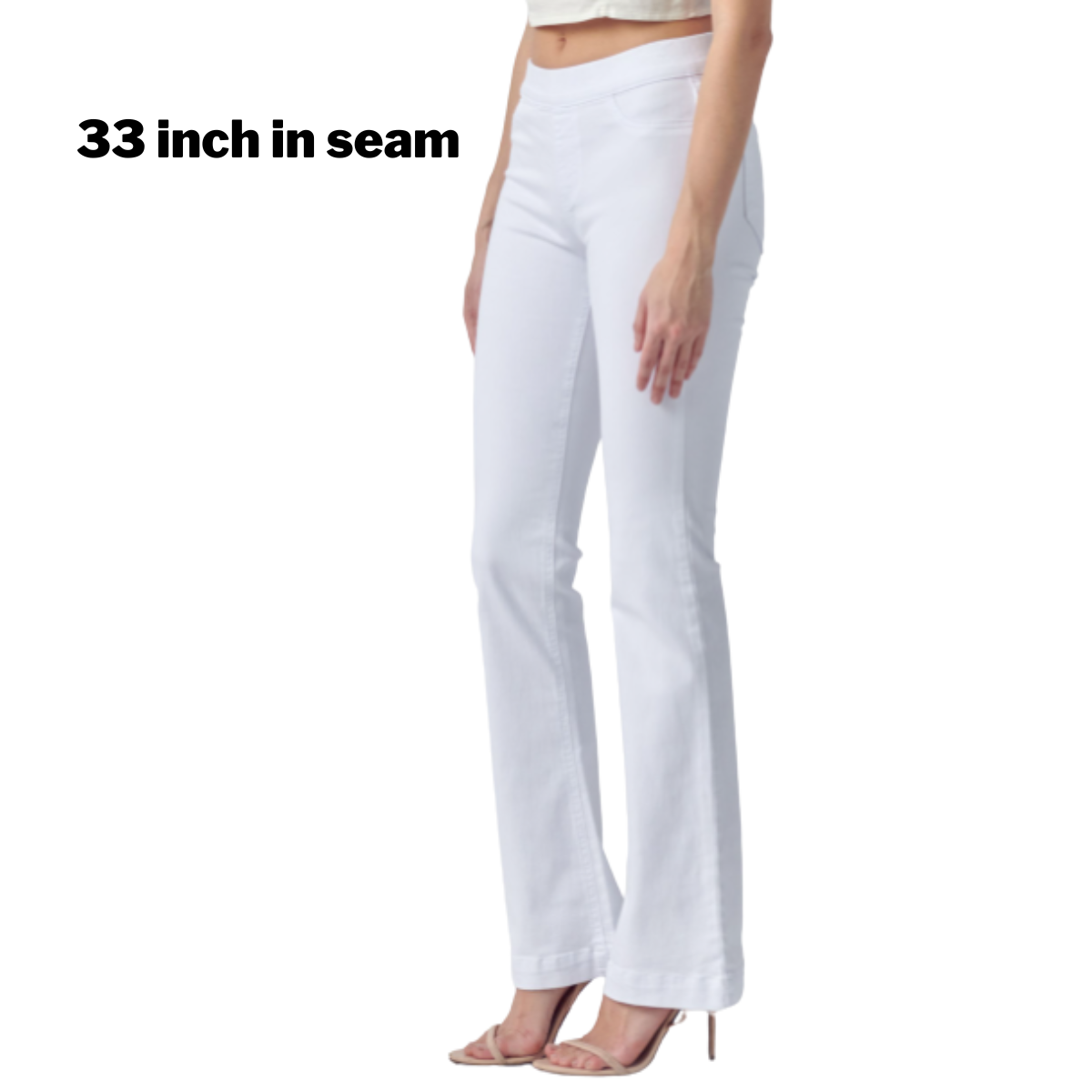 A woman in Cello Pull On Jeans, white with a 33-inch inseam, stands sideways in high heels.