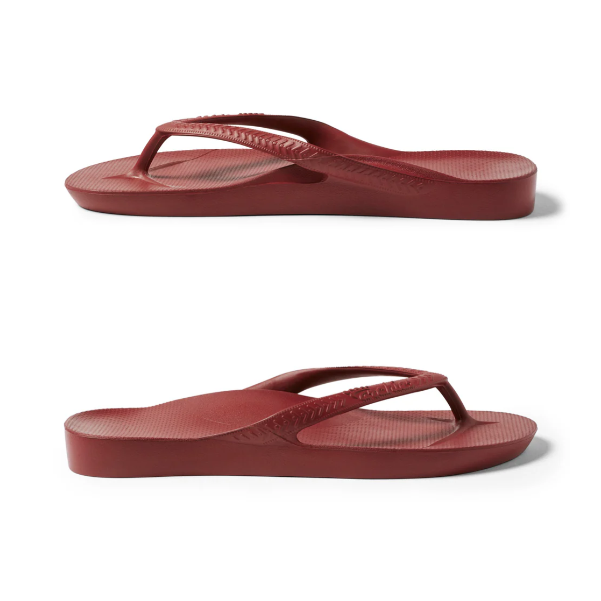 Two views of the Archies Flip Flops in Sangria by ARCHIES FOOTWEAR LLC, featuring a thick sole and textured footbed made from closed cell foam, shown from the side on a plain white background.