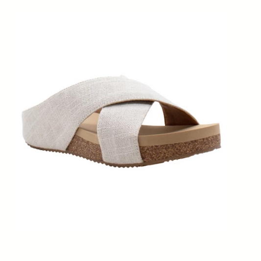 The Ablette Slide Sandal in Bone Linen by Volatile from PV Footwear features wide fabric crisscross straps, an ultra-comfort EVA insole, and a cork-textured sole, shown on a white background.