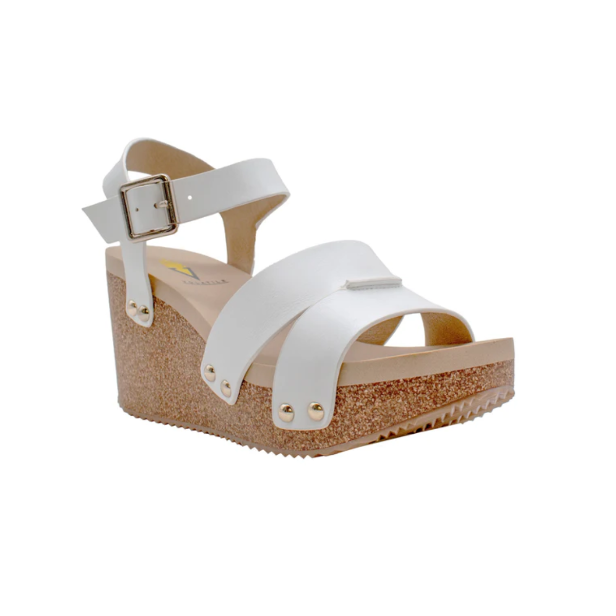 The Agnes Wedges Sandal in White by Volatile features a cork wedge sole, dual foot straps, a metal buckle at the ankle, and a textured bottom for grip.