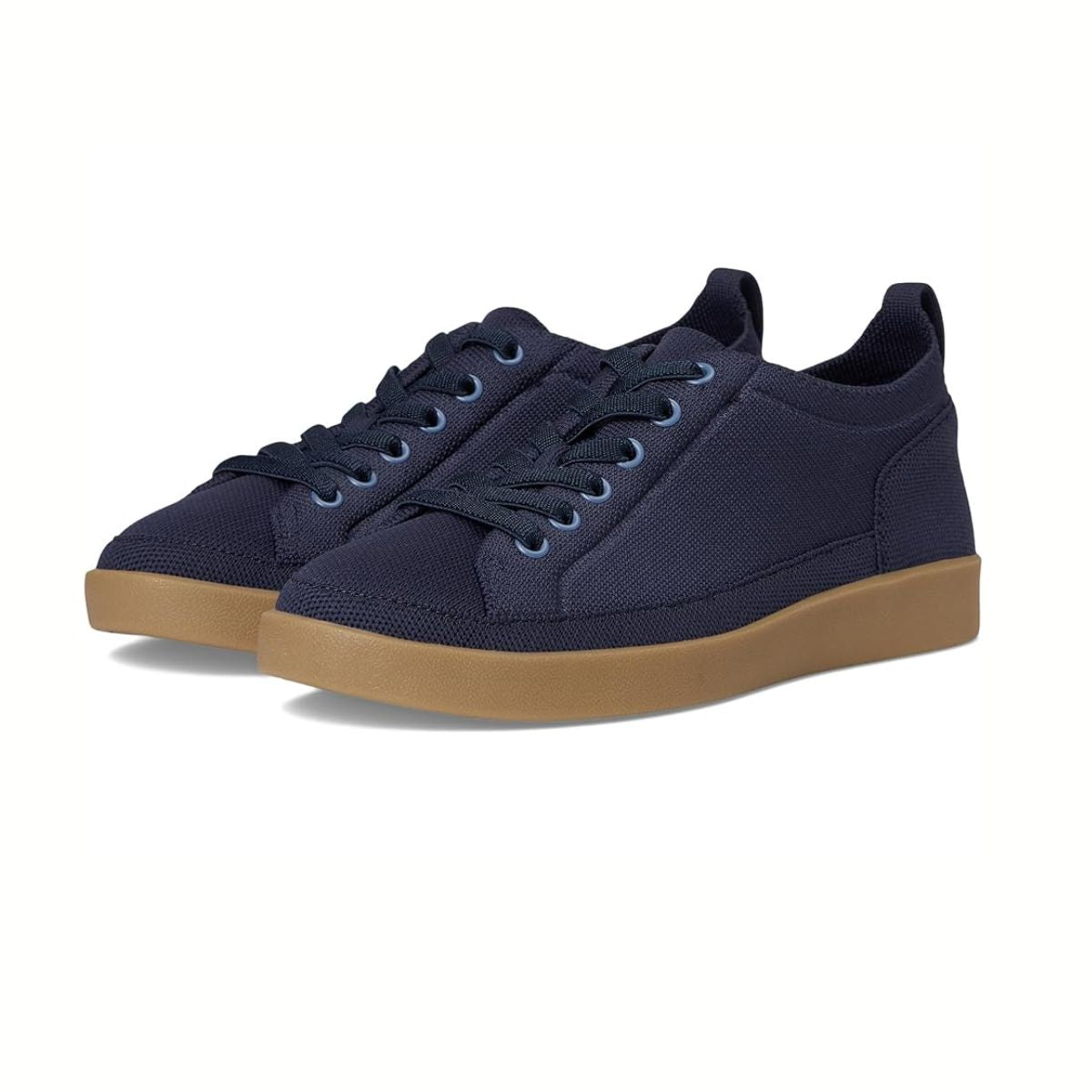 The Winny Knit Tennis Shoe by Vionic in Navy from Caleres features dark blue laces, light brown rubber soles, and comfortable arch support, shown against a white background.