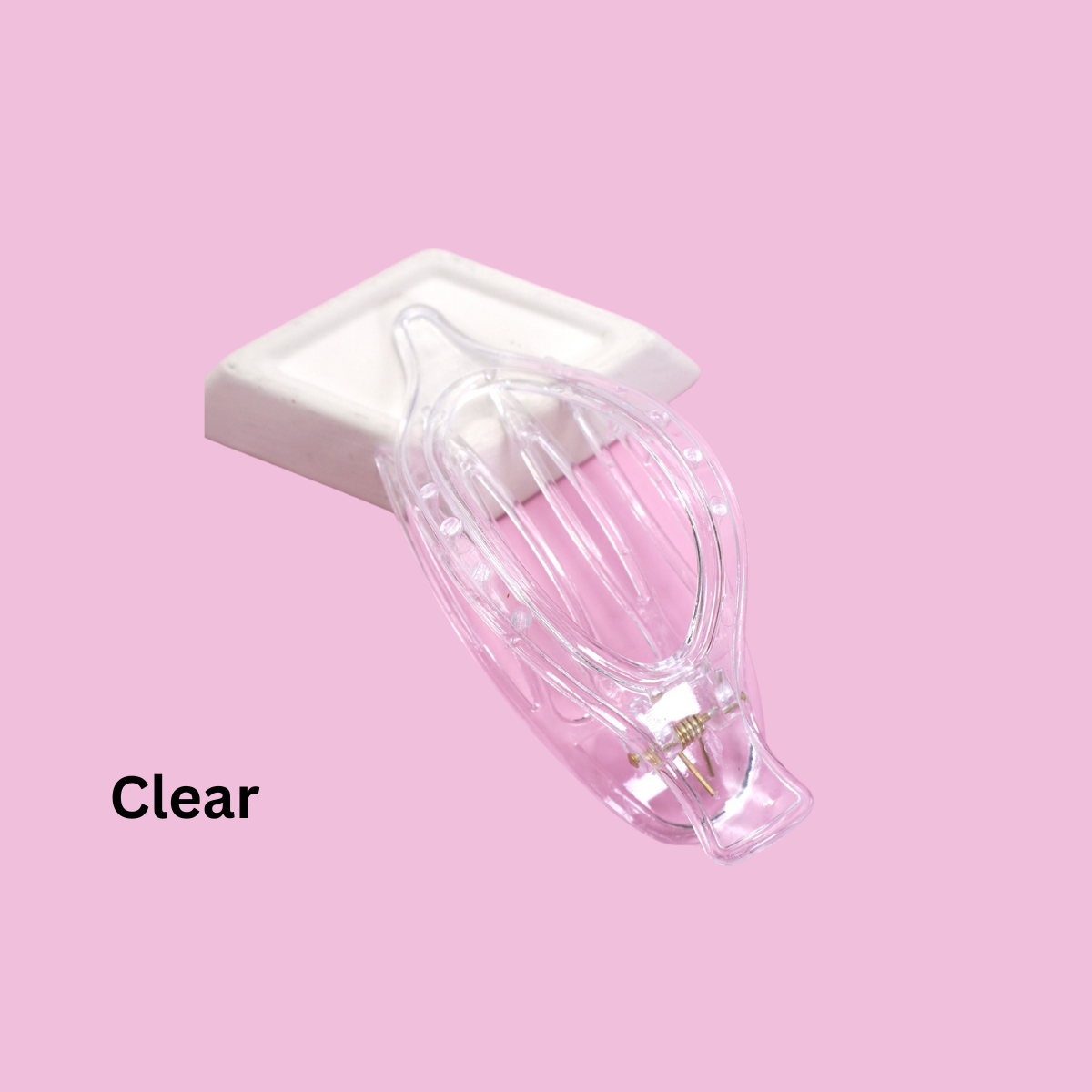 A set of FASHION GO Oval Lay Down Flat Claw Hair Clips in assorted colors rests on a white rectangular pad against a pink background, offering secure grip and comfort, with "Clear" in black text.