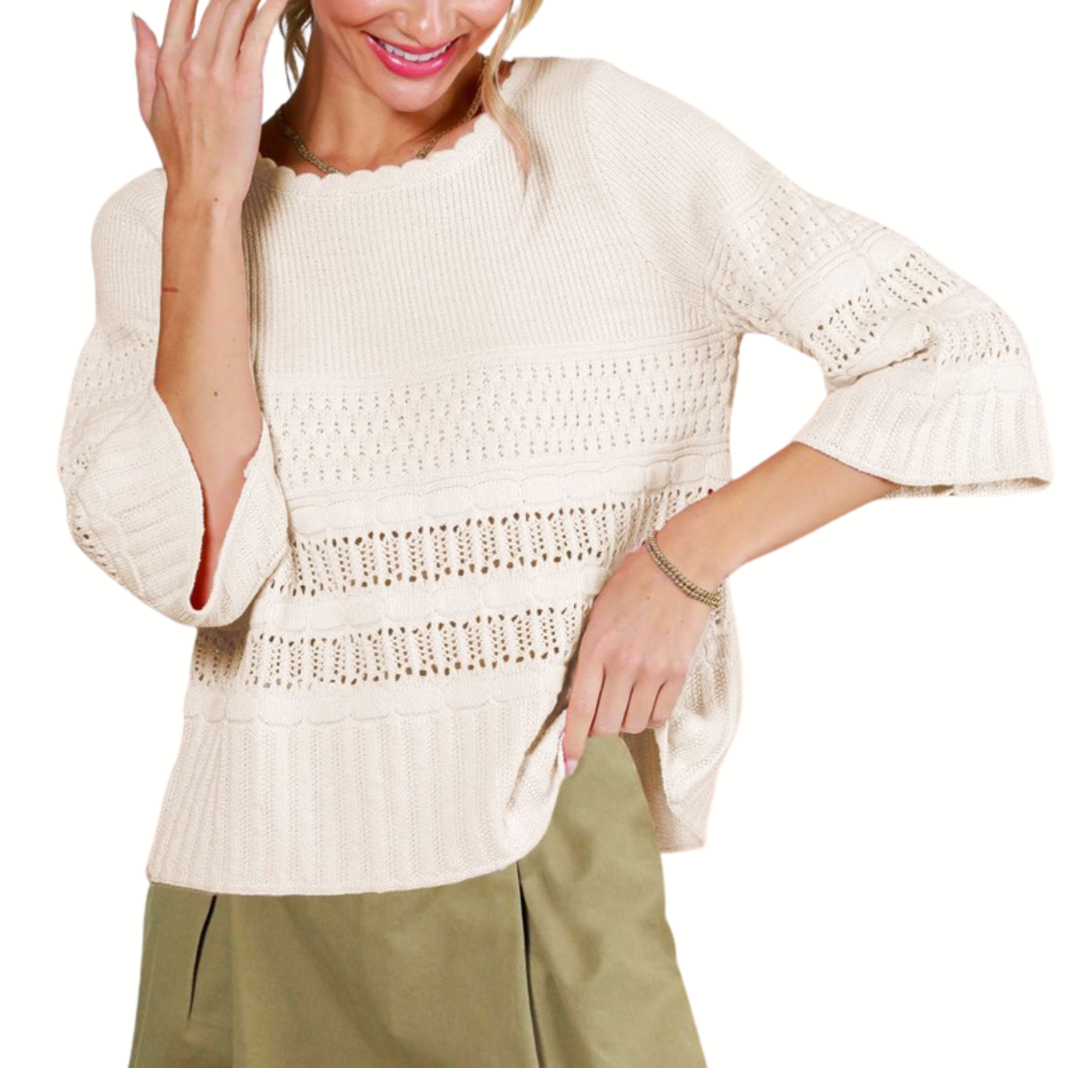 A woman smiles while wearing the Vine & Love 3/4 Sleeve Sweater, featuring a cream hue and lace textures, paired with olive green pants.