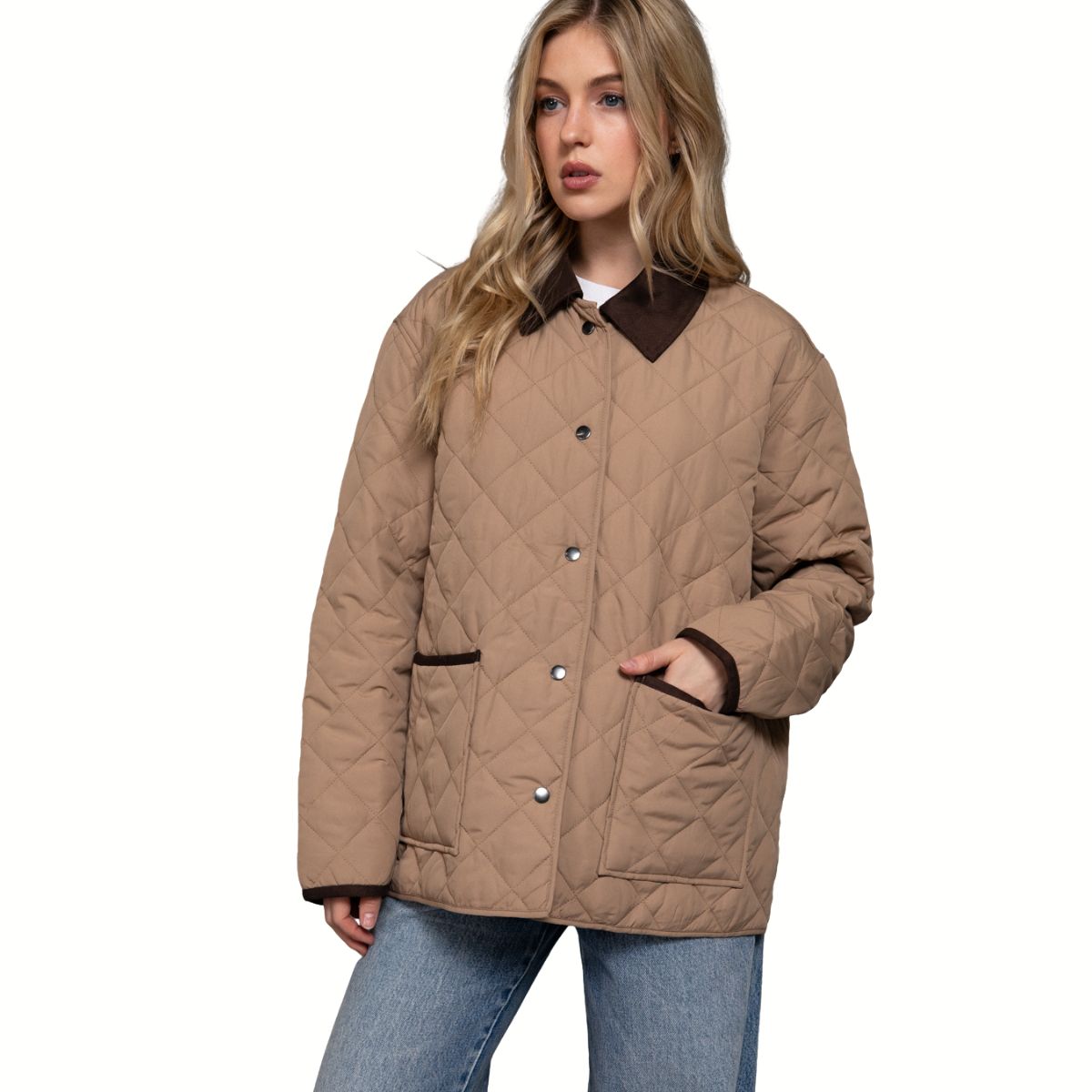 A woman in the FASHION GO Long Sleeve Puffer Jacket with Contrasting Collar, featuring snap buttons, wears blue jeans and stands against a white background.