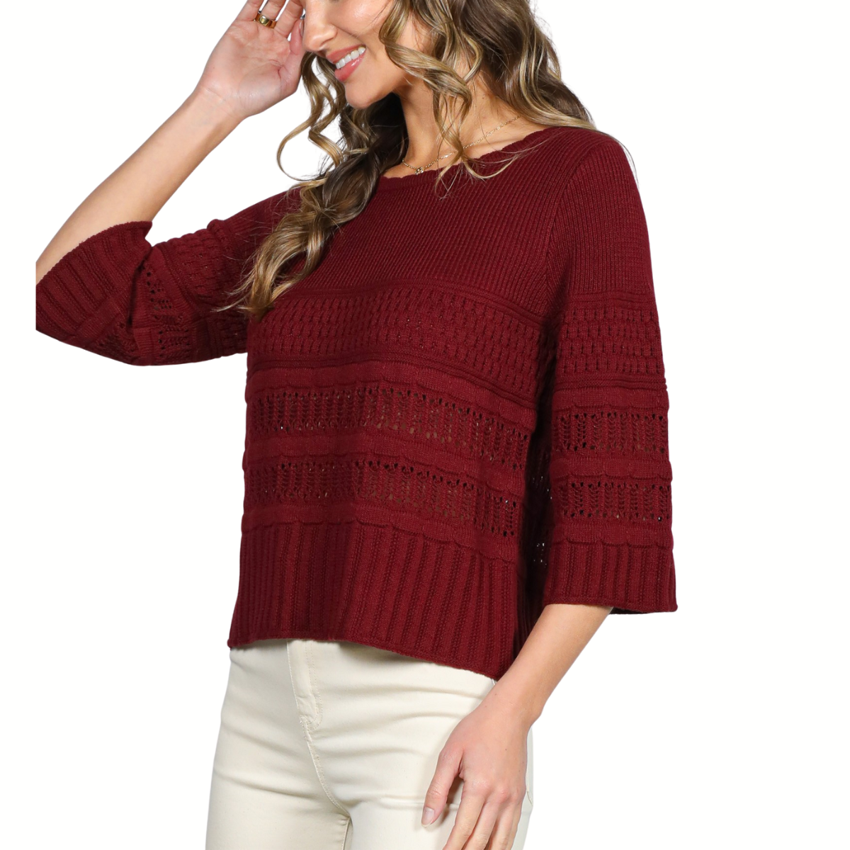A woman poses with one hand in her hair, wearing the Vine & Love 3/4 Sleeve Sweater in maroon and white pants.