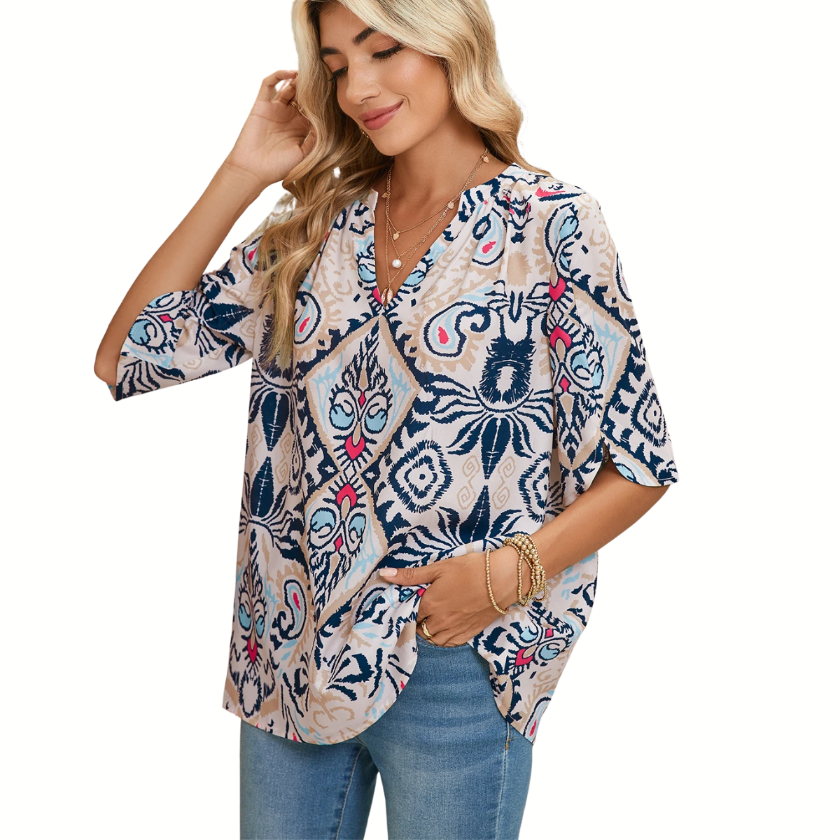 A woman in a FASHION GO White Abstract Print V-Neck Blouse and jeans poses gracefully, one hand in her pocket while the other gently touches her hair.