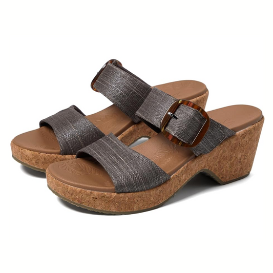 A pair of brown strappy SKECHERS Brystol Lux Foam Heel in Chocolate wedge sandals with cork soles and an adjustable velcro buckle.