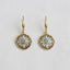 The Enamel Drip Art Dangle Earrings by Ellemadera feature round, floral-patterned enamel pendants in teal, pink, and white on gold dangle settings. Displayed on a white background, these palace style earrings evoke vintage-inspired charm and bring elegant flair to any outfit.