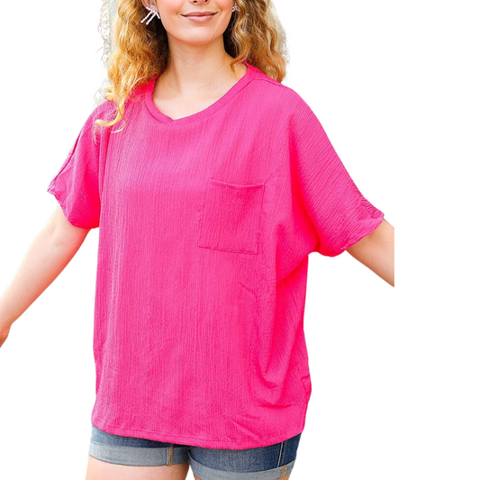 A young woman wearing a pink Crinkle Fabric Boxy Blouse in Pink from FASHION GO and shorts.
