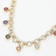 Sensibling Corp.’s 14K Gold Plated Colorful Round CZ Charm Station Chunky Chain Necklace features chunky circular links adorned with small, multicolored round cubic zirconia charms evenly spaced along the bottom. Displayed on a white background, this elegant necklace brings a vibrant yet sophisticated accent to any ensemble.