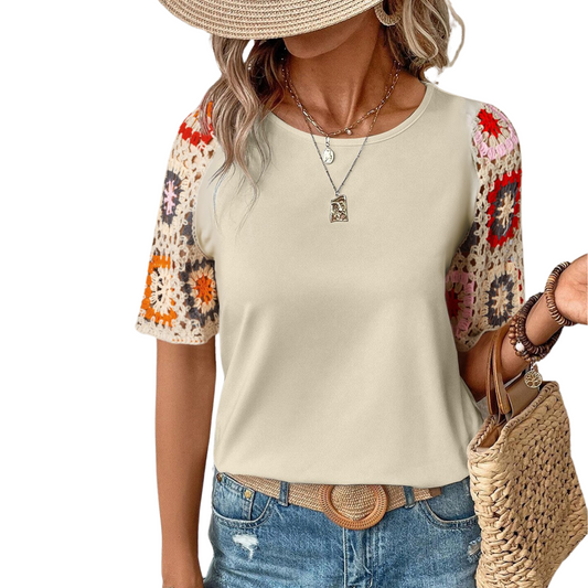 Woman wearing a FASHION GO Crochet Sleeve Short Sleeve Top in Khaki, a straw hat, and denim jeans, accessorized with a necklace and holding a wicker bag.
