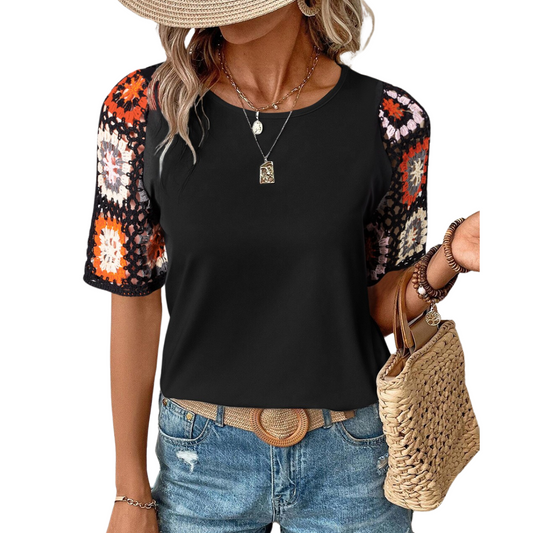 A woman wearing a FASHION GO Crochet Sleeve Black Short Sleeve Top with denim shorts and accessories, holding a straw bag.