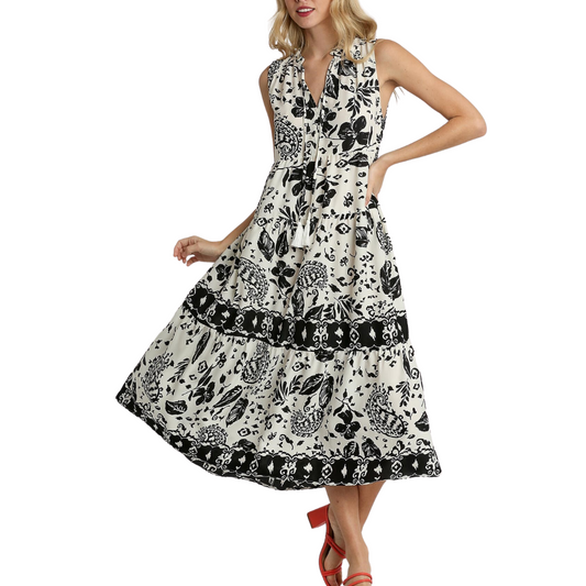 A woman wearing a black and white spring Floral Sleeveless Midi Dress by FASHION GO.