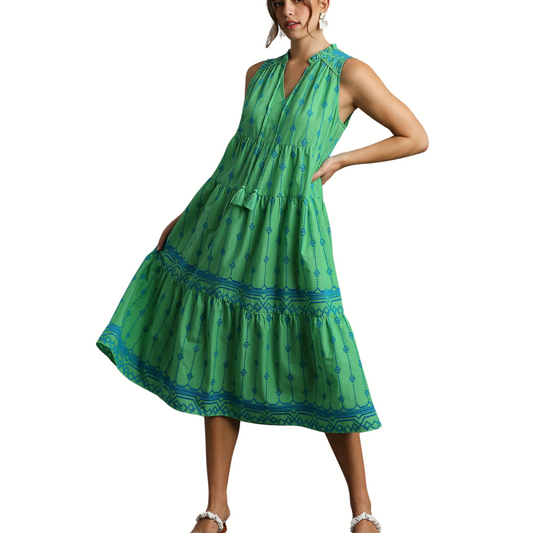 The woman is wearing a sleeveless FASHION GO Embroidery A-line Midi Dress in Green with blue trim.