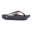 A single black OOFOS LLC OOLala Lux in Latte flip-flop with a metallic strap and strategic arch support is isolated on a white background.