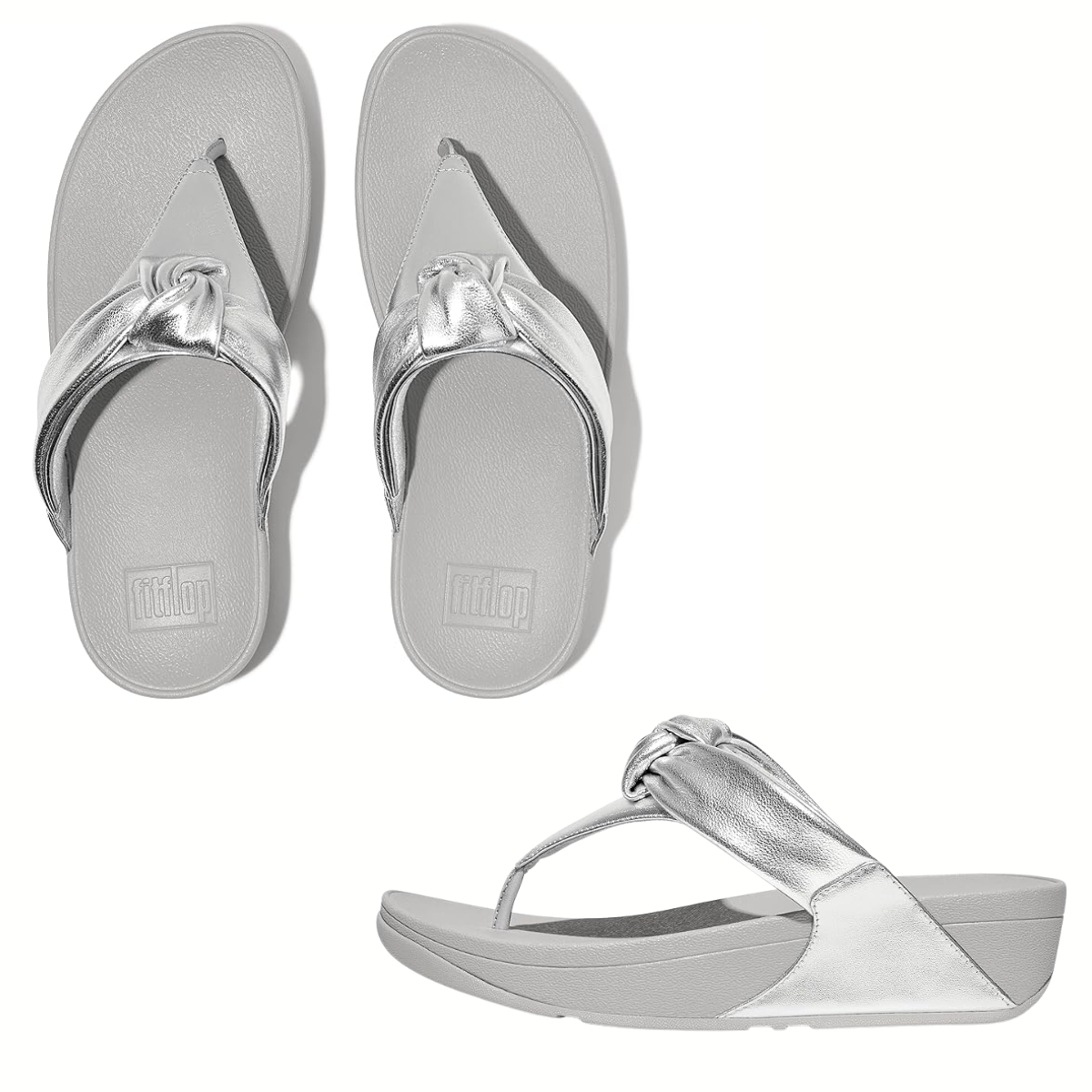 A pair of LuLu Padded Knot Flip Flops in Silver by FITFLOP USA LLC with a twisted thong strap design.