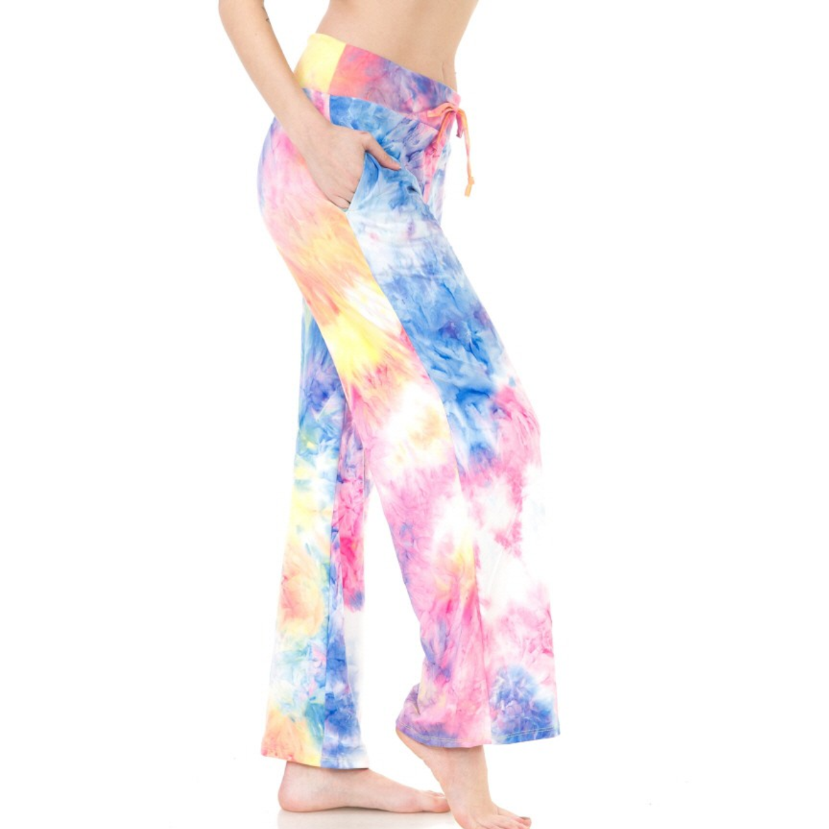 A person wearing colorful FASHION GO Buttery Soft Pajama Pants with Drawstring, standing with one hand in the functional pocket, enjoying the buttery soft fabric.