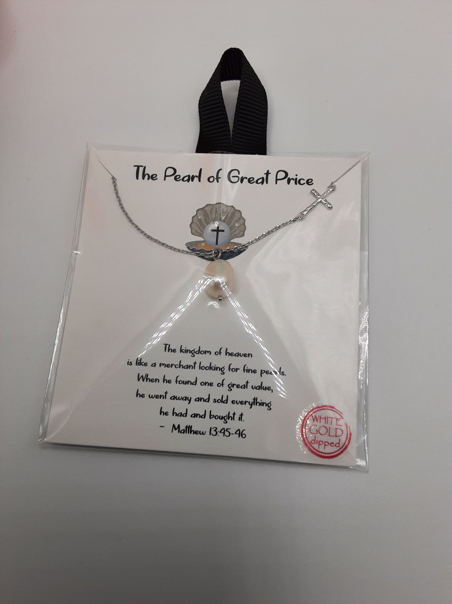 The *Pearl of Great Price 16 inch Necklace* by SPECIAL EFFECTS features a cross pendant and includes text reading "The Pearl of Great Price" with a biblical quote from Matthew 13:45-46 on the packaging. A small round label indicates "White Gold dipped.
