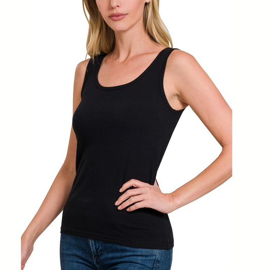 A woman wearing a Fashion Go cotton black tank top and jeans.
