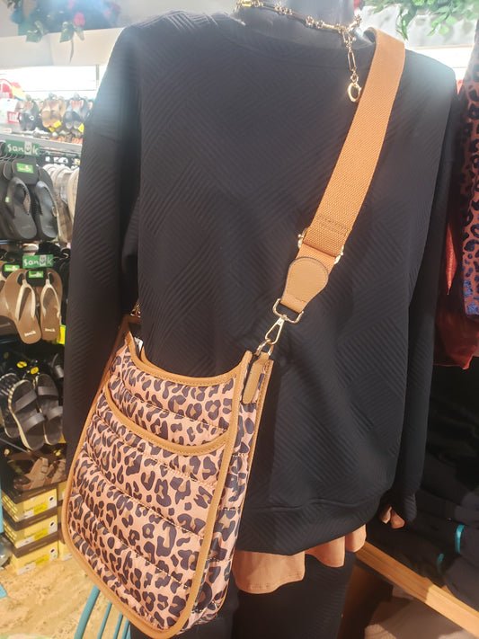 Mannequin displaying a Fashion Go Leopard Quilted Puffer Cross Body Bag in a retail setting.