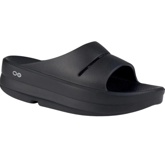 A single black OOFOS OOMEGA SLIDE SANDAL with a thick sole and a rounded toe, displayed against a white background.
