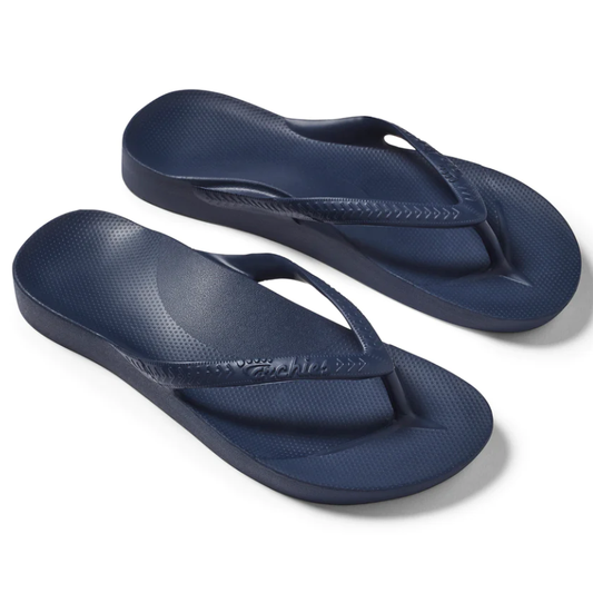 A pair of blue ARCHIES Flip Flops in NAVY on a white background, designed for orthotic support and comfort by ARCHIES FOOTWEAR LLC.