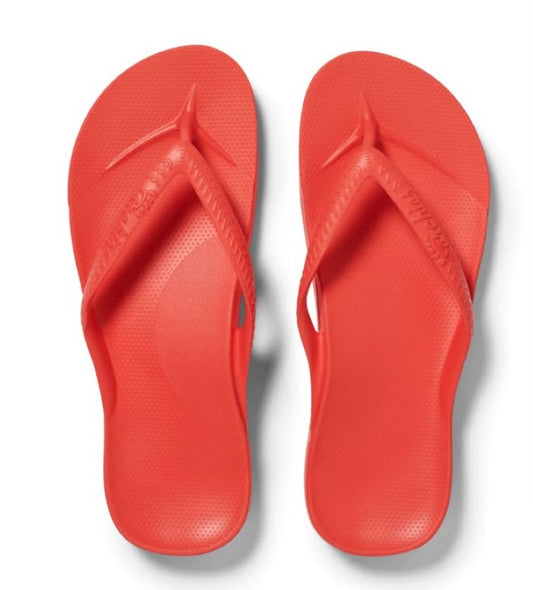 A pair of red ARCHIES Coral flip-flops isolated on a white background.