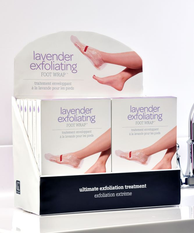 Retail display of GIFTCRAFT FOOTWRAP boxes, featuring packaging that illustrates feet with wraps and promotes it as the "ultimate exfoliation treatment" enhanced with lavender oil for efficient dead skin removal.