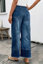 A person wears 1 the Woman Drawstring Seam Detail Raw Hem Wide Leg Denim Pants, beige sandals, and a white top while standing outdoors near a bench and a white wall.