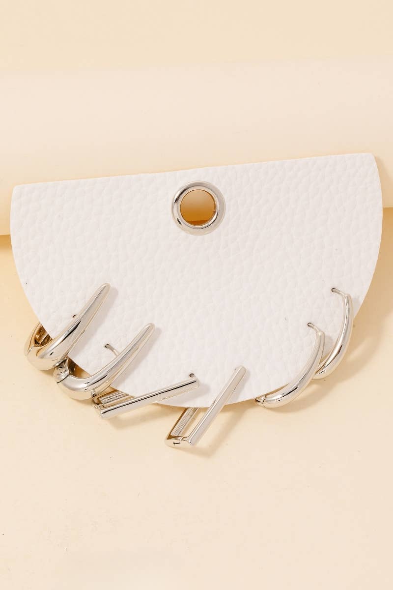 The Mixed Long Oval Hinge Hoop Earrings Set by Anarchy Street features multiple silver-tone oval hoops with hinged closures, offering a modern accessory option for your collection.