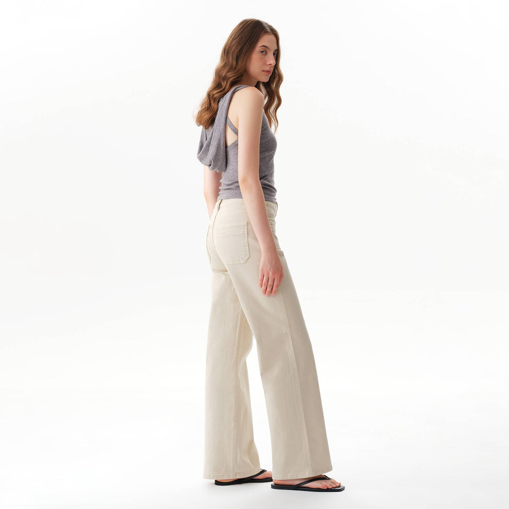 A woman in a grey tank top and Faire Off White Mid Rise Straight Pants.