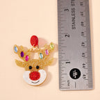 Glitter Rudolph Reindeer Earrings featuring a glittery gold reindeer with a red nose and multicolored gem antlers, shown next to a stainless steel ruler for scale.