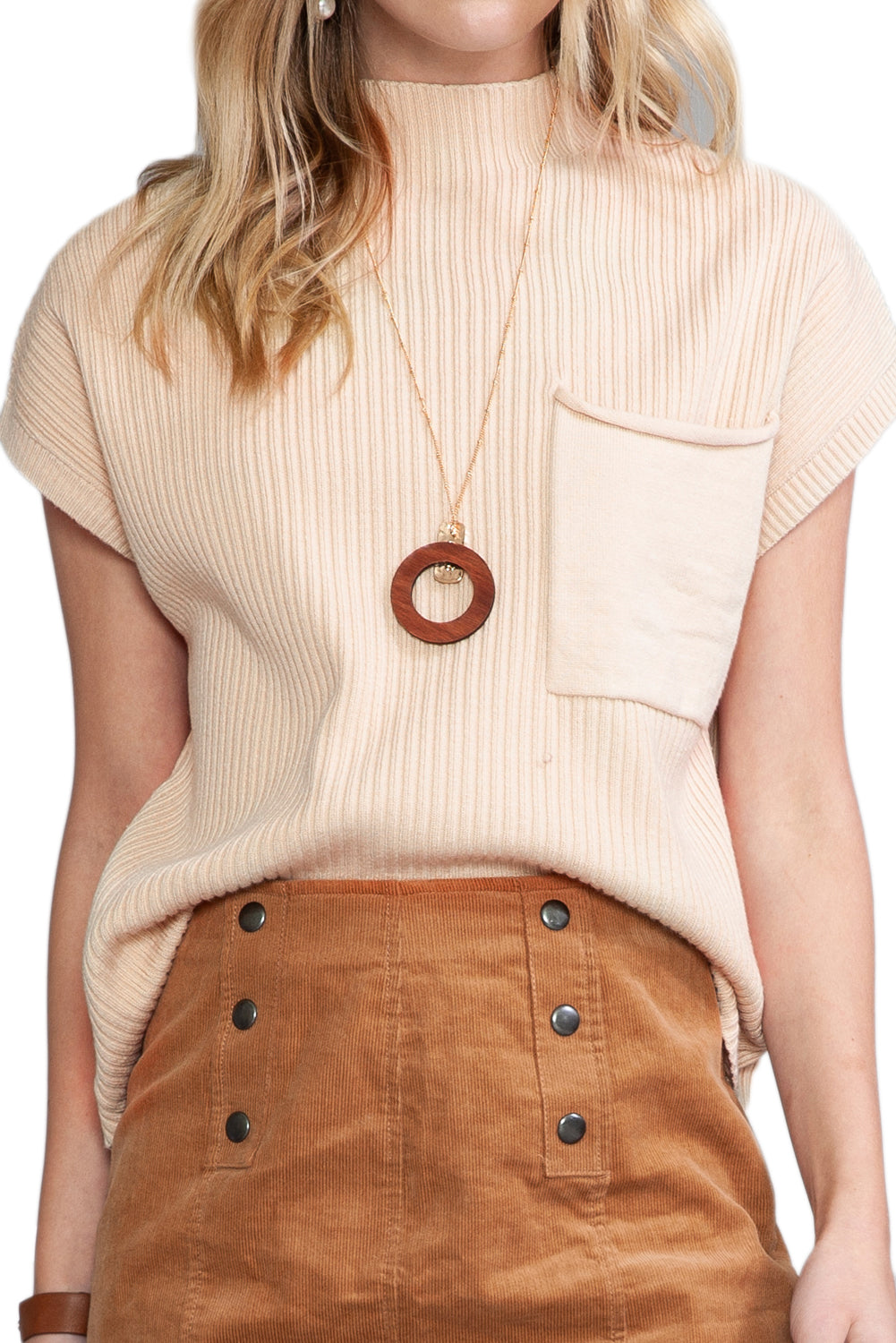 A person is wearing Shewin's Patch Pocket Ribbed Knit Short Sleeve Sweater in beige, paired with a wooden circle necklace and a brown buttoned skirt, ideal for transitional weather.