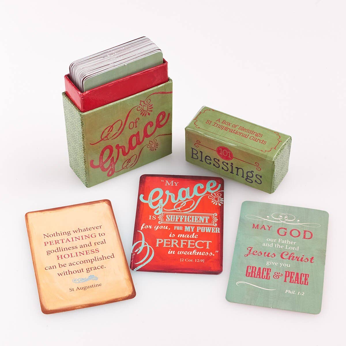 A “Box of Blessings of Grace” from Christian Art Gifts is displayed, featuring blessings cards with inspirational quotes, along with a smaller box labeled “10 Blessings.” Three cards with religious quotes are positioned in front of the boxes.