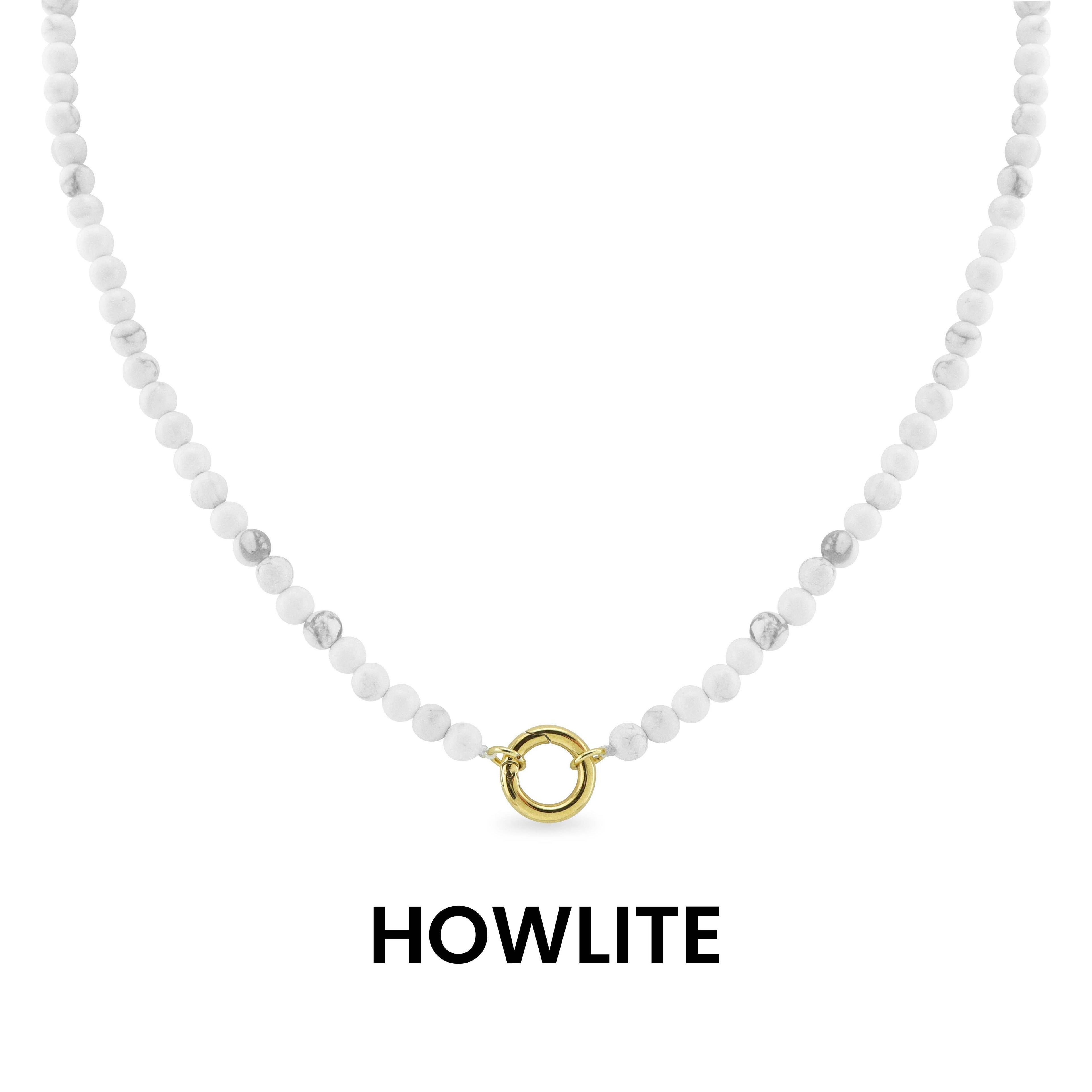 WJW Semi Precious Natural Stone Charm Keeper Necklace crafted with white howlite stones and finished with a circular 18K Gold PVD-coated clasp, elegantly displayed on a white background with the word "HOWLITE" below—a timeless accessory designed for enduring style.