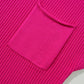 Close-up of the bright pink, ribbed knit fabric with a patch pocket on the short sleeve sweater by Shewin.