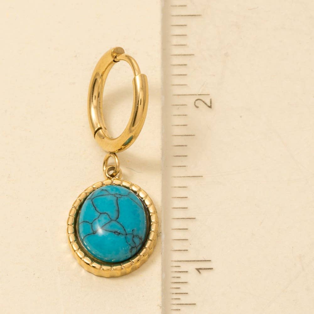 Anarchy Street's Oval Turquoise Stone Drop Earrings feature a gold hoop with an oval turquoise pendant. Perfect for turquoise lovers, these earrings measure about 2 inches long.