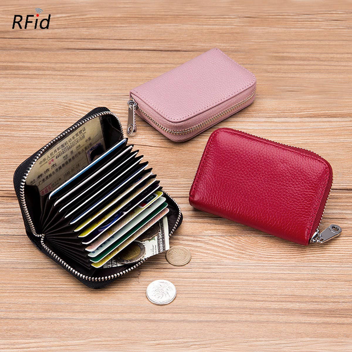 Three ACCITY CARD WALLET Anti-Theft Wallets—one open with cards, cash, and coins, two closed in pink and red—rest on a wooden surface. Main image