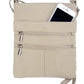 A Large cowhide leather crossbody shoulder bag by Roma Leathers, Inc. in beige, featuring two zippered pockets and an adjustable strap, holds a partially visible white smartphone in the top pocket.