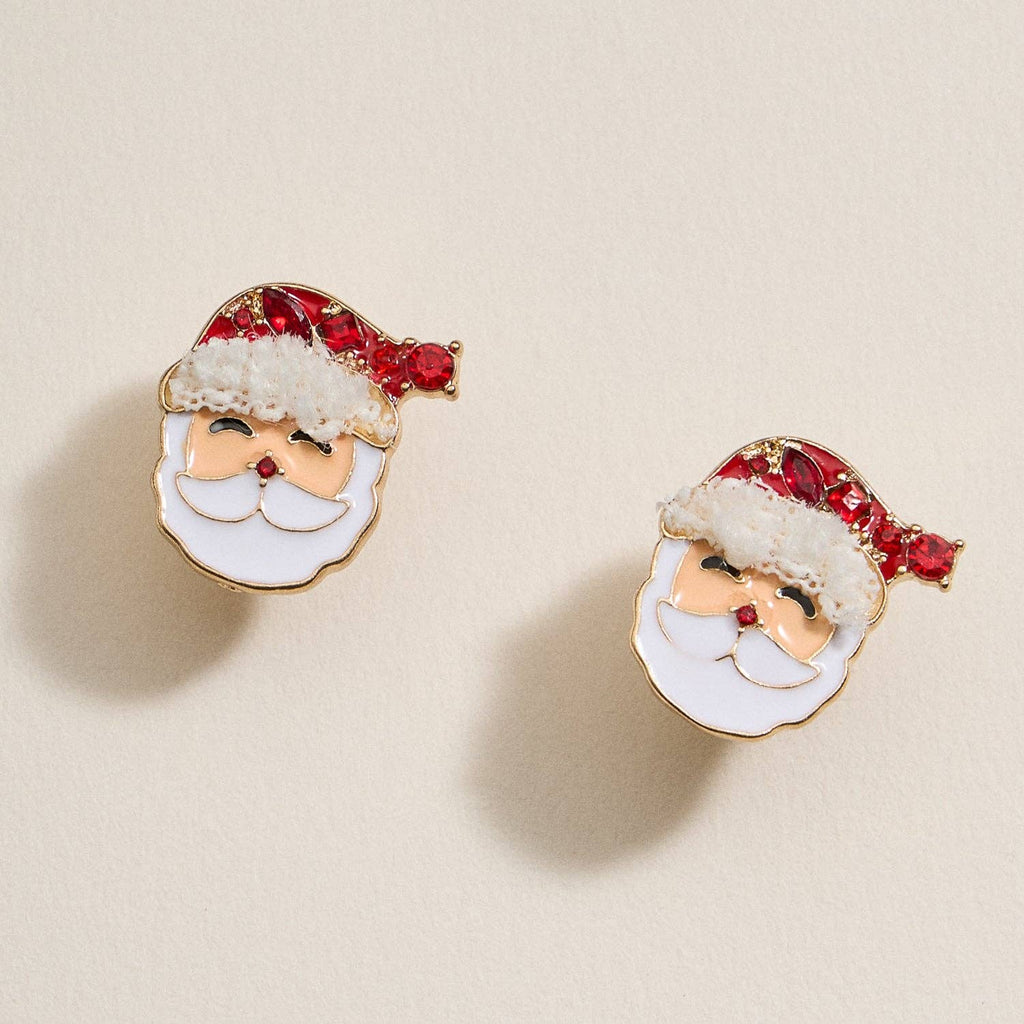 Discover the Santa Claus Stud Earrings by Lilla Haven—adorable stud earrings featuring jolly Santa faces with red rhinestone hats and white beards, shown on a beige background. The perfect festive jewelry to brighten up your holiday look!.