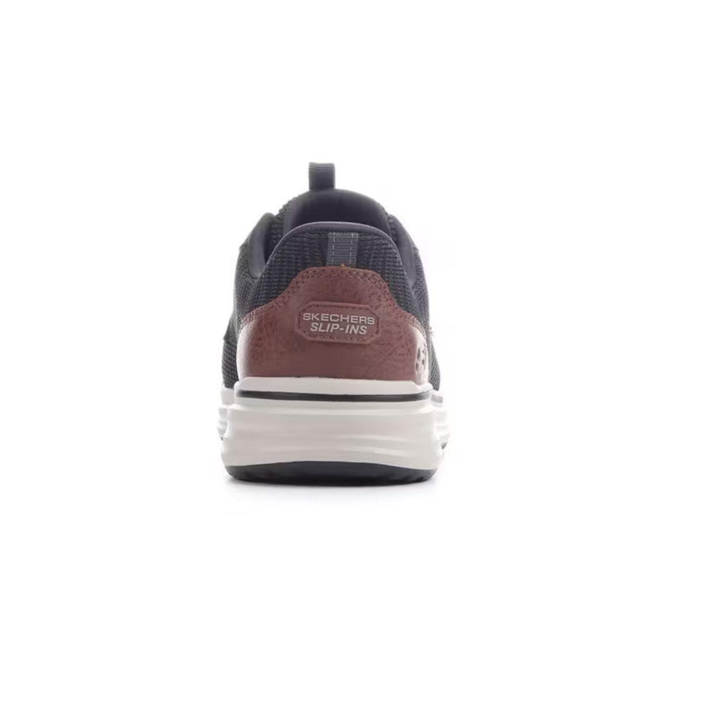 A rear view of the SKECHERS Slip-ins Relaxed Fit Sterling - Ramone men’s sneaker in black and brown showcases the heel tab and white sole against a white background.