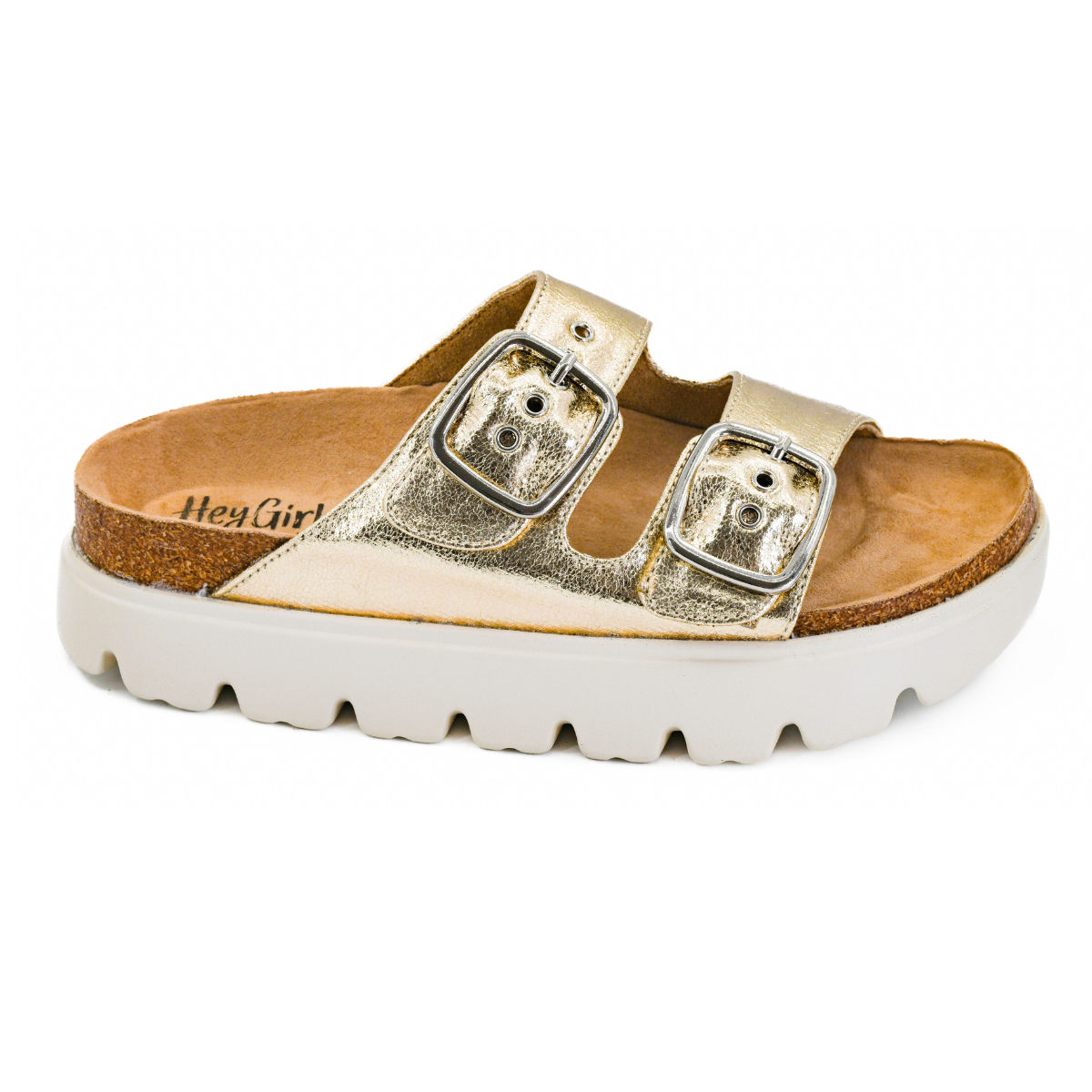 The Rumor Has It Platform Slide by Flipflops & Whatnots features two adjustable buckle straps, a metallic finish, cork footbed, and a chunky white ridged sole.