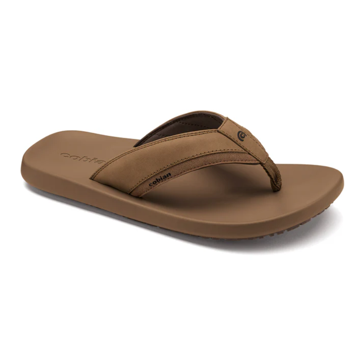 The COBIAN Men's Venture Flip Flop in brown features a wide cushioned strap, flat sole, and comfortable footbed. This casual tan sandal is shown against a plain white background. Main image