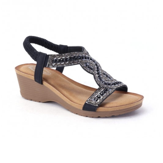 The SUMMER RIO Black Beaded Low Heel Wedge features a slip-on style with an open toe, crisscross straps, elastic ankle strap, and a tan cushioned sole for comfort.