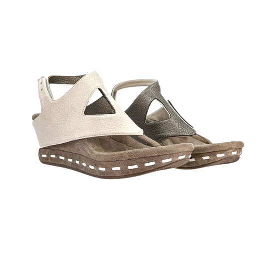 Step into style with the Venitia Reversible Wedge Off White to Pewter by MODZORI: open-toe, mid-wedge sandals featuring thick brown soles and geometric cutout uppers in contrasting off white and pewter leather.