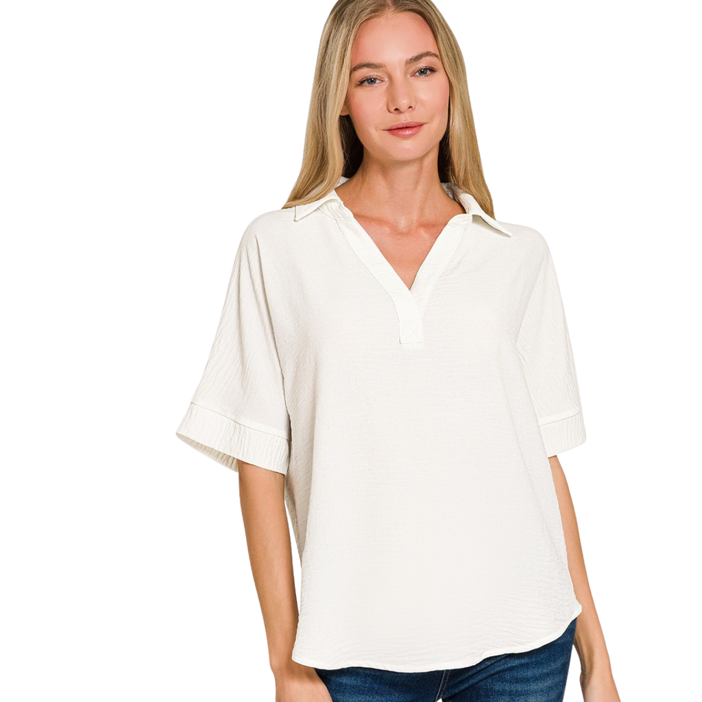 A woman models the Flipflops & Whatnots Woven Airflow Collared Top—a lightweight, short-sleeve V-neck blouse—against a plain white background, ideal for effortless summer comfort and style.