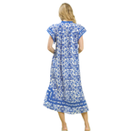 A woman faces away, wearing the Umgee Abby Blue Print Midi Dress featuring blue and white floral patterns and short sleeves.