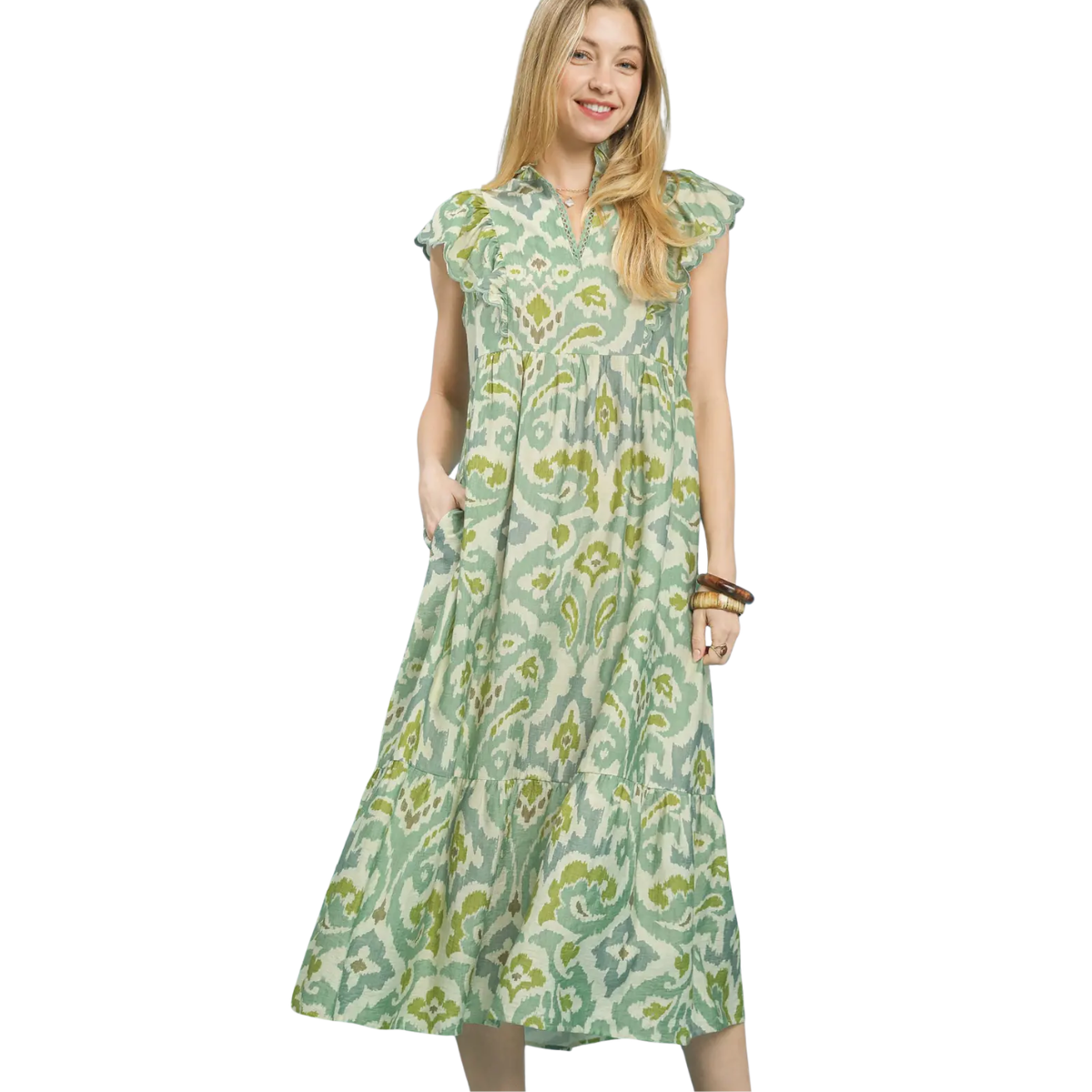 A woman wears the Umgee Ruffle Sleeve Ikat Midi Dress, featuring a light green and blue pattern, short flutter sleeves, and pockets, set against a white background. Main image